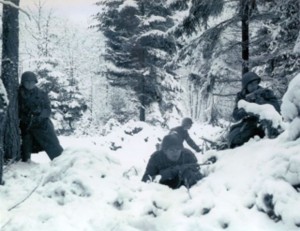 Soldiers taking refuge in fox holes during the Battle of the Bulge | US Army