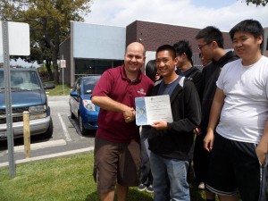 Monterey Park Rotary President Tim Motts presenting the Interact certificate for the Mark Keppel Interact Club to President Michael Wu.