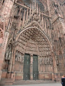 We stand before the magnificent entrance to the towering medieval cathedral in Strasbourg.