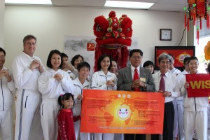 Mayor Antonio “Tony” Cartagena of Walnut (third from right) and Yun-Gong Hsu, director of the Taipei Economic and Cultural Office in Los Angeles (second from right) make the hand gesture for “An Era of Conscience.”