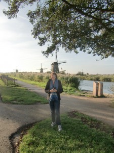  Dolores poses with the idyllic windmill scene behind her.