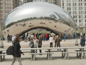 People crowd around to see their distorted images in front of the famous Cloud Gate at Millenium Park.
