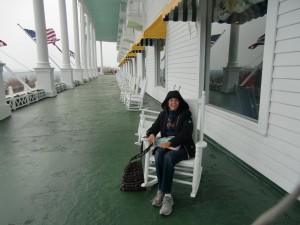 Although the weather is chilly Dolores relaxes on the hotel's famous porch for a brief moment. Note all the rocking chairs.