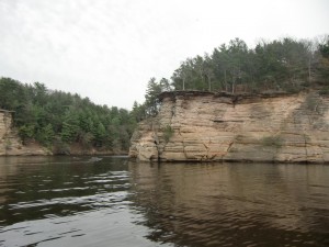This is a view from our boat of the forested rocky bluffs.