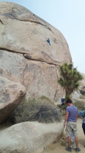 This large outcropping is called Cap Rock. Note the climber scaling the rock without equipment.