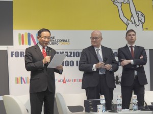 Dr. Hong, Tao-Tze, president of the Federation of World Peace and Love (FOWPAL), first from left, delivers an appreciation speech after accepting the FIRMA Global Peace Award during the Turin International Book Fair, May 13, 2019 in Turin, Italy.