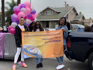   Parade participants from Bossi Gal Wig Academy show support for the International Day of Conscience during the celebration of Dr. Martin Luther King Jr.'s birthday in Los Angeles on Jan. 20, 2020.