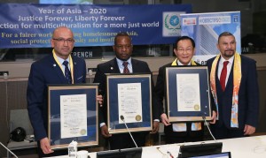 From left, Ali Gedikoglu, president of COJEP International, Hugues Sanon, UN representative of COJEP International, and Dr. Hong, Tao-Tze, president of FOWPAL, are honored by New York State Assemblymember Philip Ramos at the UN in New York. (AP Images)